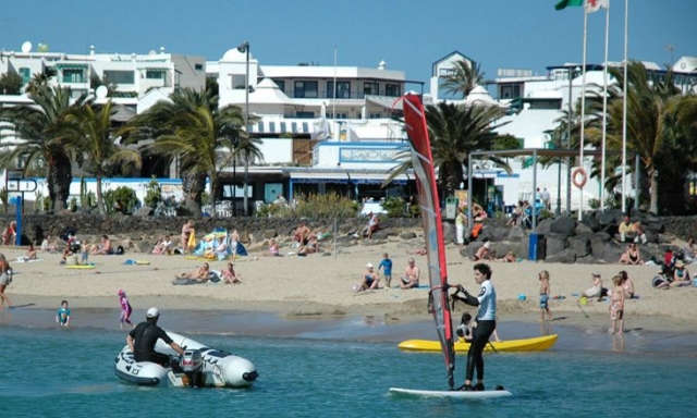  Practicing windsurfing on the beach 
